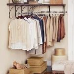 bedroom storage hack: install a clothes rack in an empty corner KSMVVZO