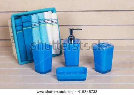 blue bathroom accessories with blue and white on wooden shelf VWKYXGG