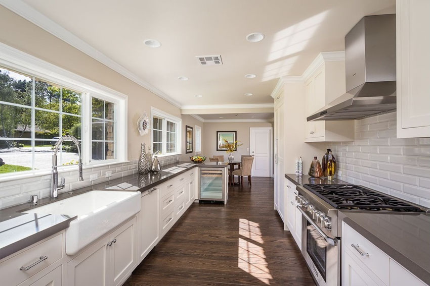 traditional galley kitchen with white cabinets backsplash WAYUHXF