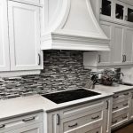black and white kitchen backsplash ideas black or grey linear glass tile backsplash with crisp white cabinetry DTMGXTY