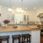 interior white kitchen island with butcher block top transitional CFNQJRV