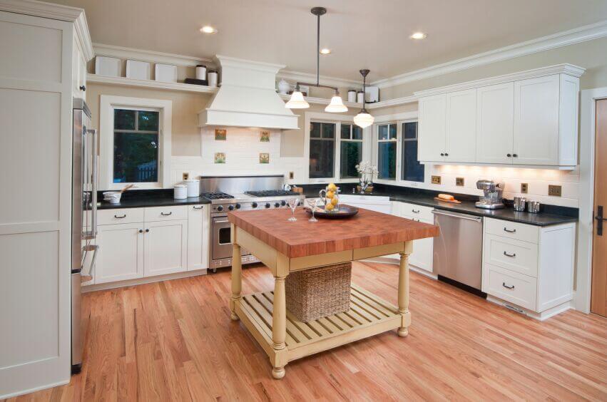 kitchen with white cabinets and black countertops the dark counters in this kitchen break up the white WZFOBMA