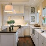 kitchens with white cabinets and dark floors light sconces by sink...white cabinets dark floors FWUGJXZ