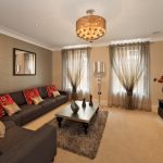 living room accent wall with brown furniture two layers of sheer curtains provide privacy, but still let YQPBVPV