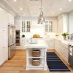 long narrow kitchen island with seating decoration: a pair of polished nickel industrial pendants hang over KELMTSH