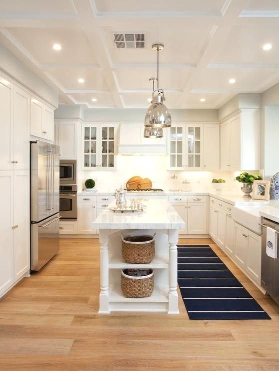 long narrow kitchen island with seating decoration: a pair of polished nickel industrial pendants hang over KELMTSH