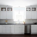 white kitchen cabinets with black countertops LHWZTZV