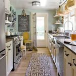 Galley kitchen with cream cabinets and blue wall @elise Anderson