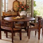 round breakfast table with curved wooden benches | when i wander