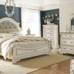 Realyn Chipped Two Tone Upholstered Panel Bedroom Set from Ashley .