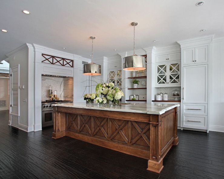 Beautiful white kitchen with wood island, brushed nickel drum .