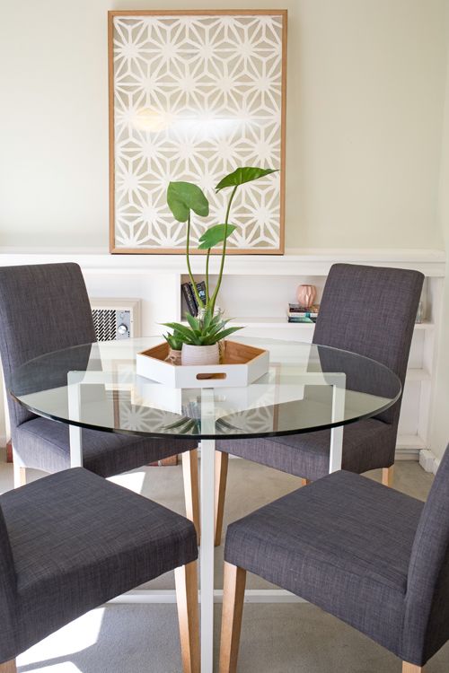 Small dining area, small apartment, round glass top dining table .