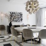 Contemporary white, gray, and black dining room boasts a large .