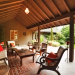 the wooden arch of this covered patio provides a sense of space and TZGKWFR