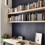 wall bookshelves dark feature wall with natural wood shelving to highlight. beadboard  panelling. LNWAUPJ