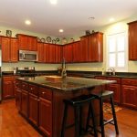 cherry kitchen cabinets with granite countertops of LVQUVWL