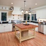 kitchen with white cabinets and black countertops the dark counters in this kitchen break up the white WZFOBMA