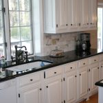 white kitchen cabinets with black countertops white cabinets black countertops and that faucet ZDHVCSE