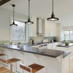 Industrial pendant lights accent a transitional kitchen picture .