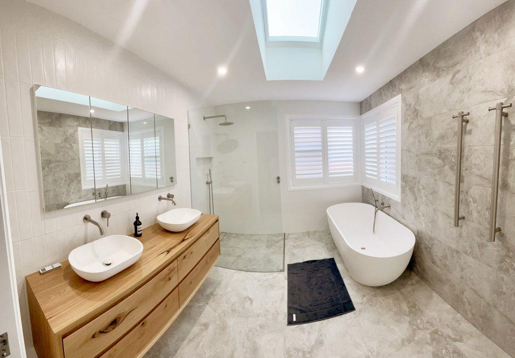 Natural light through skylights transforms your modern bathroom’s atmosphere