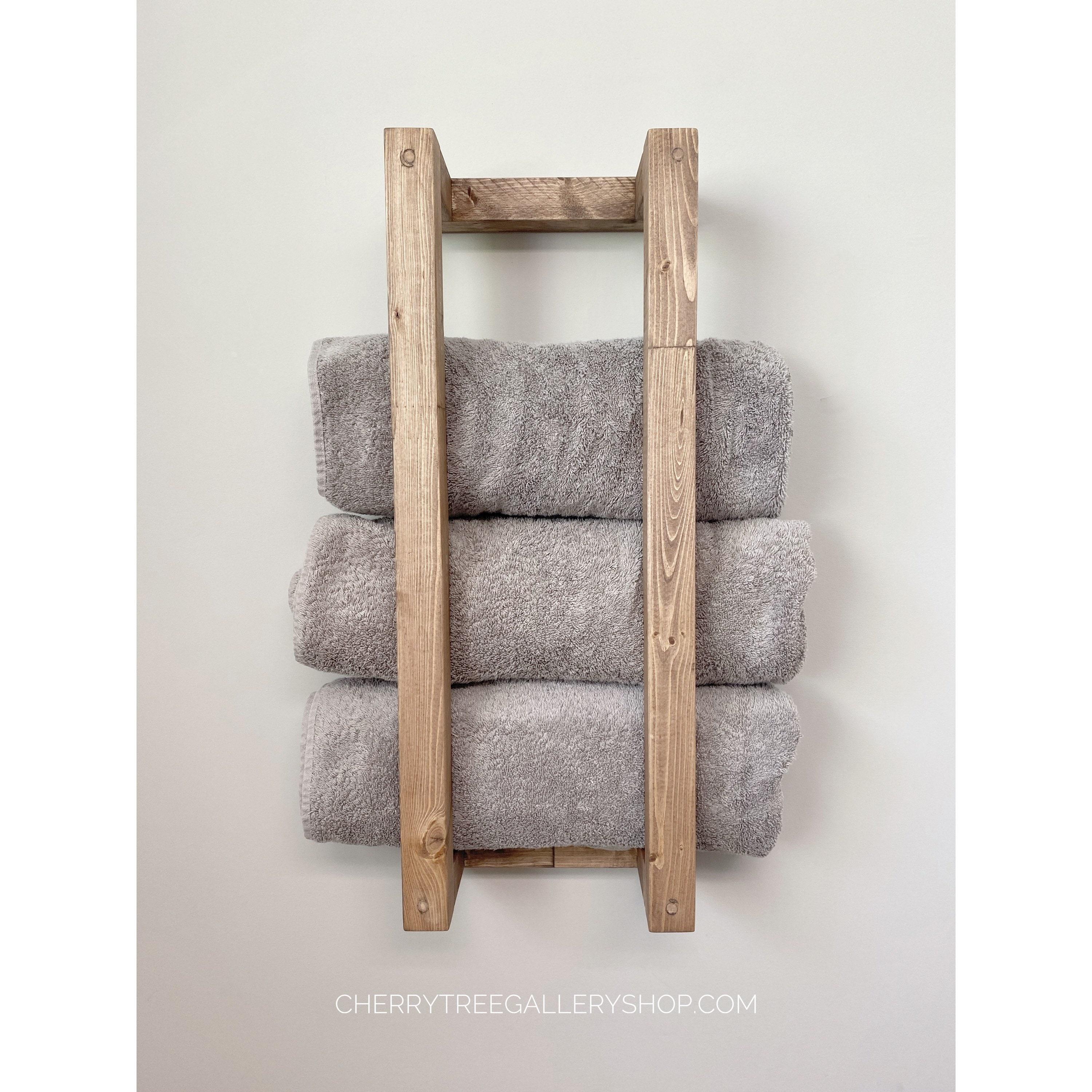 Install a wooden towel rack for convenience and style in ‌your bathroom