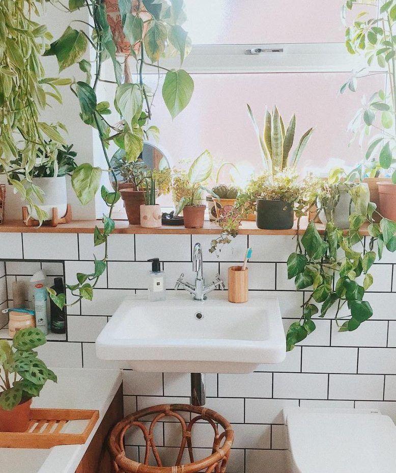 Incorporate hanging plants for a​ fresh and lively touch in your boho bathroom