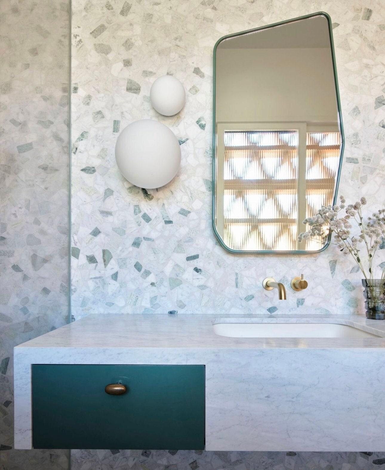 Embrace asymmetry in your décor choices for an effortlessly chic eclectic bathroom