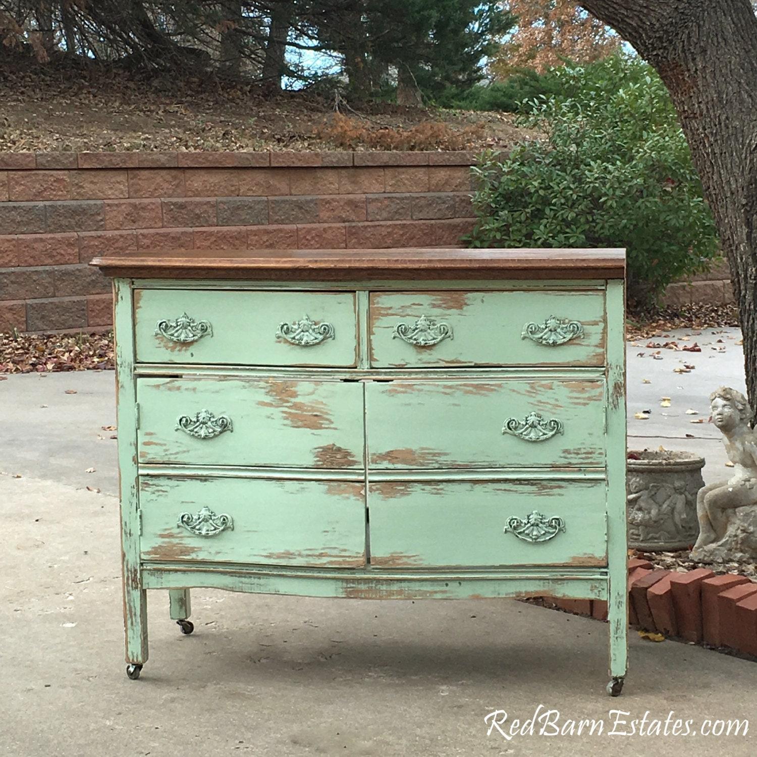 Repurposed furniture, such as a vintage dresser, can provide storage in your eclectic bathroom