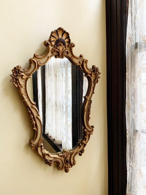 Vintage mirrors ​with ornate frames add character to your eclectic bathroom