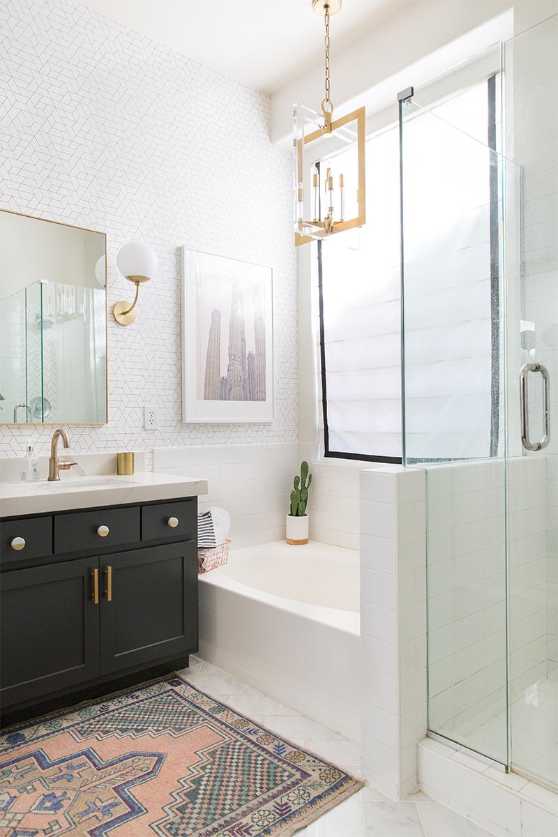 Hang mismatched mirrors in various shapes for a playful, eclectic bathroom vibe