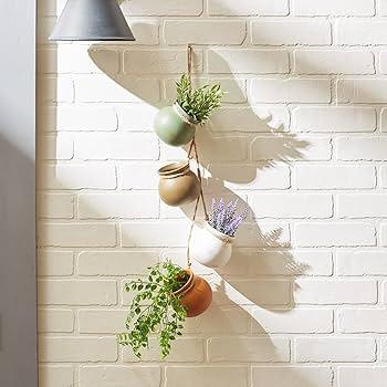 Earthy-toned ceramic pots make lovely ‍homes for your plants in a boho ‌bathroom