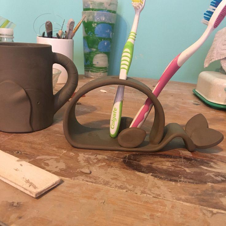 Handmade pottery mugs are perfect for holding toothbrushes in your boho ‍bathroom