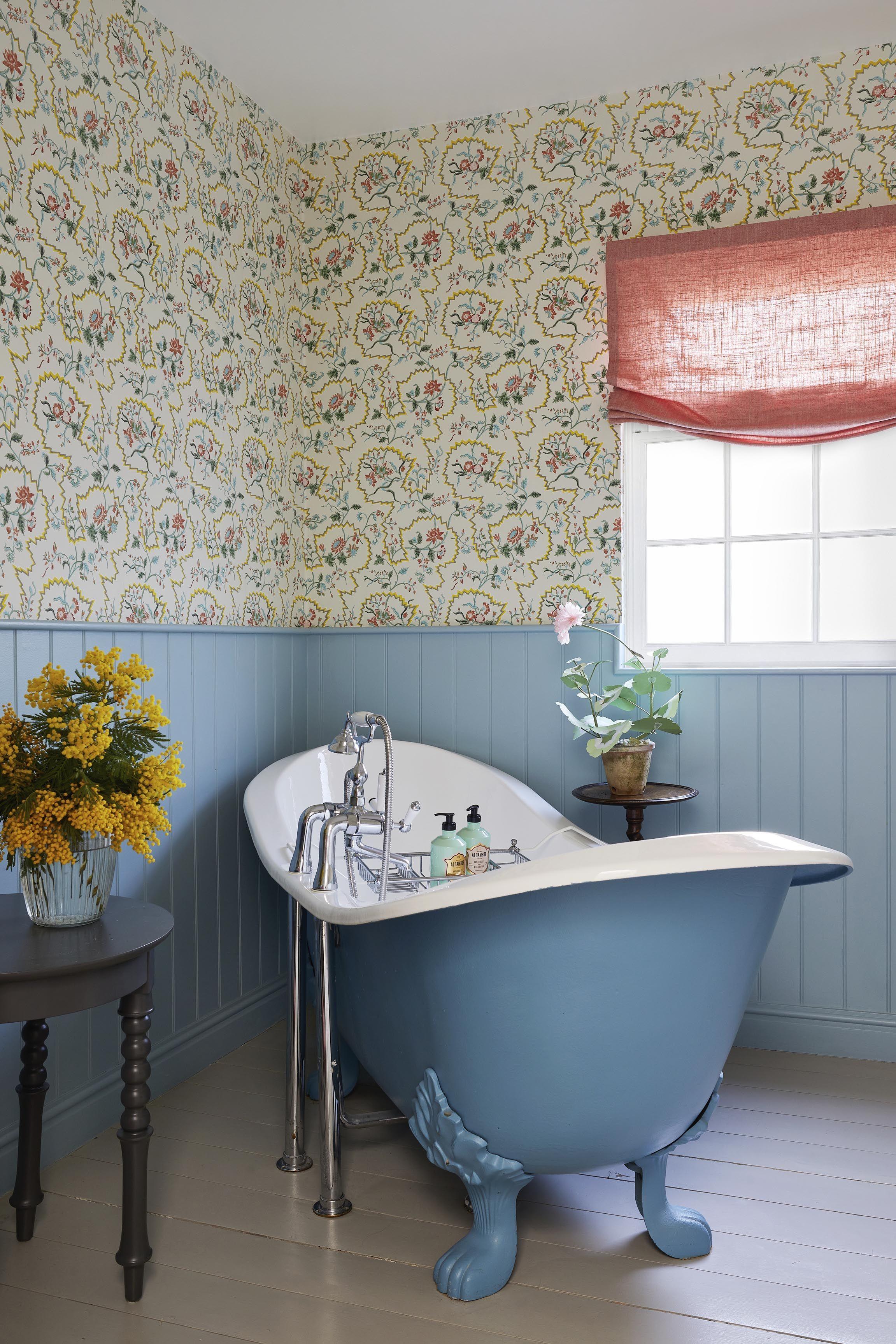 Use ​bold wallpaper patterns to make a striking statement in your eclectic bathroom