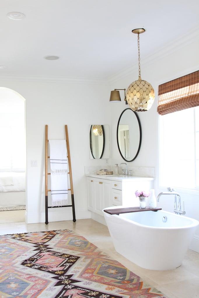 Integrate layered lighting for a cozy ambiance‌ in your boho bathroom retreat