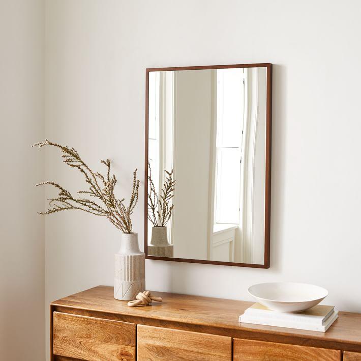 Hang a wooden mirror to enhance the wooden‍ bathroom aesthetic