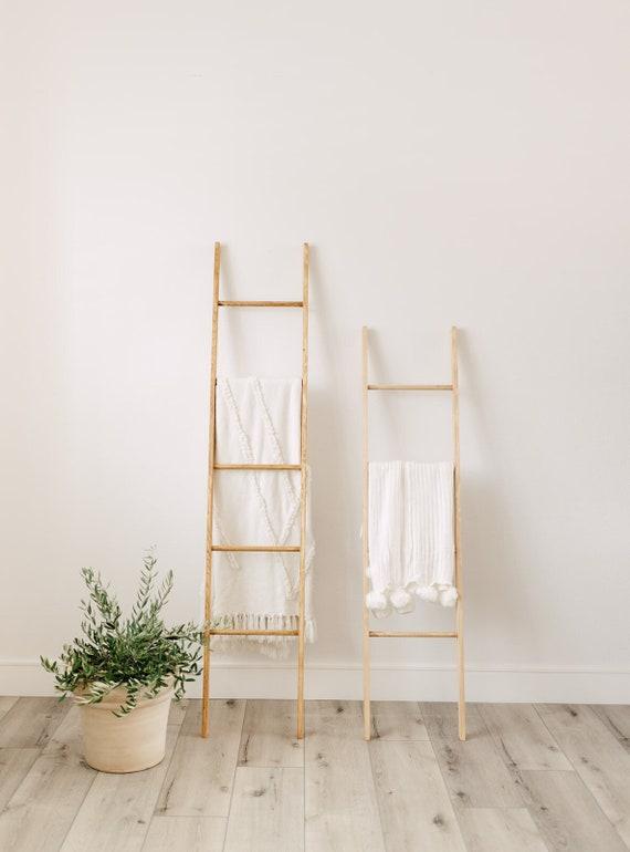 An antique ladder for towel display creates rustic charm in your‍ boho bathroom