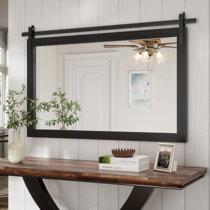 Pair rustic wooden mirrors with modern fixtures for contrast