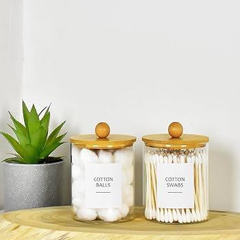 Stylish apothecary jars keep ​pins ‍and cotton⁤ swabs organized in your ‍boho bathroom