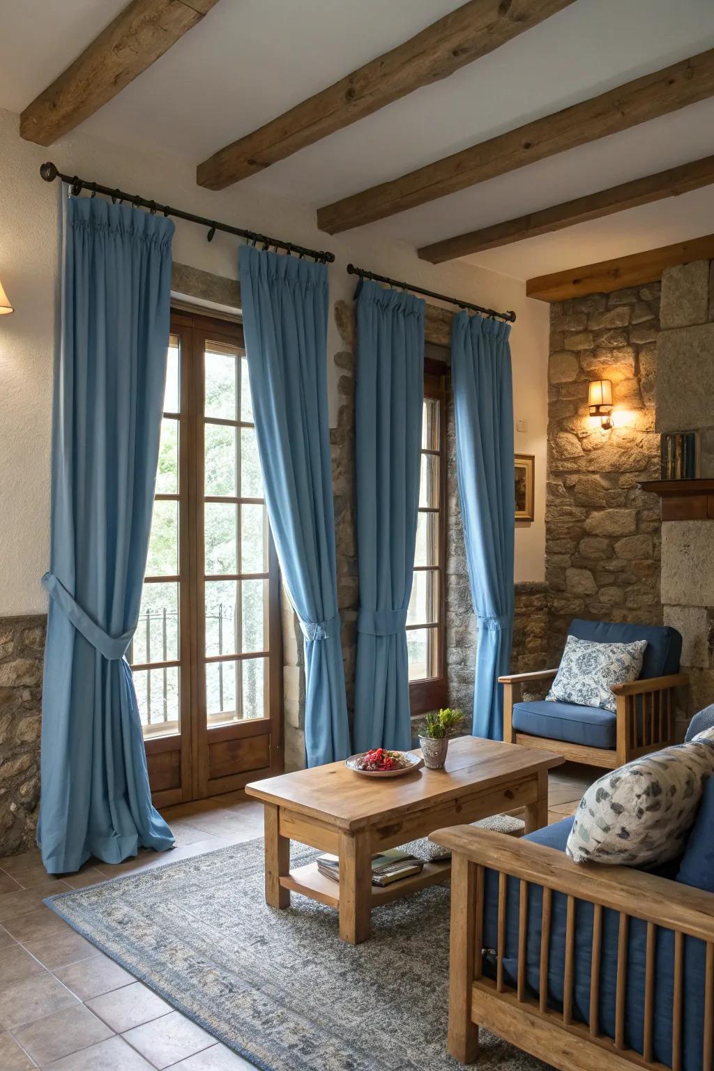 Wood and stone elements paired with blue curtains add warmth and a natural feel to the living area.