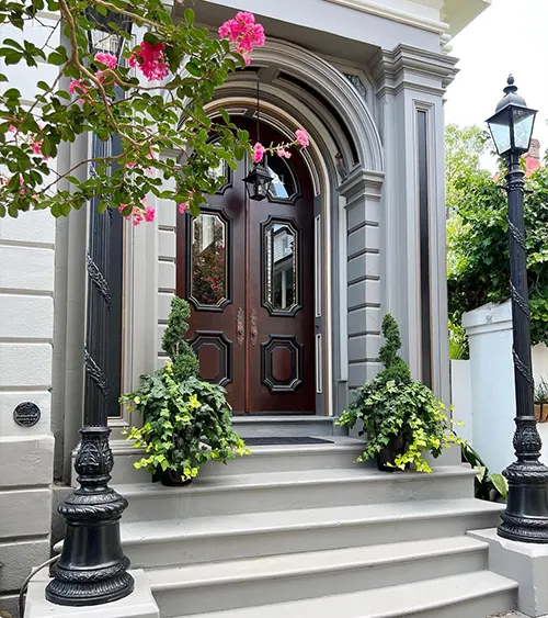 Dark wood doors with flowering vines and classic molding