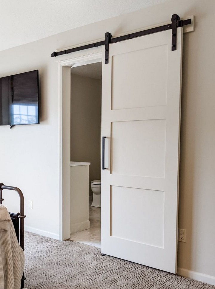 Frosted glass barn door enhancing bathroom privacy