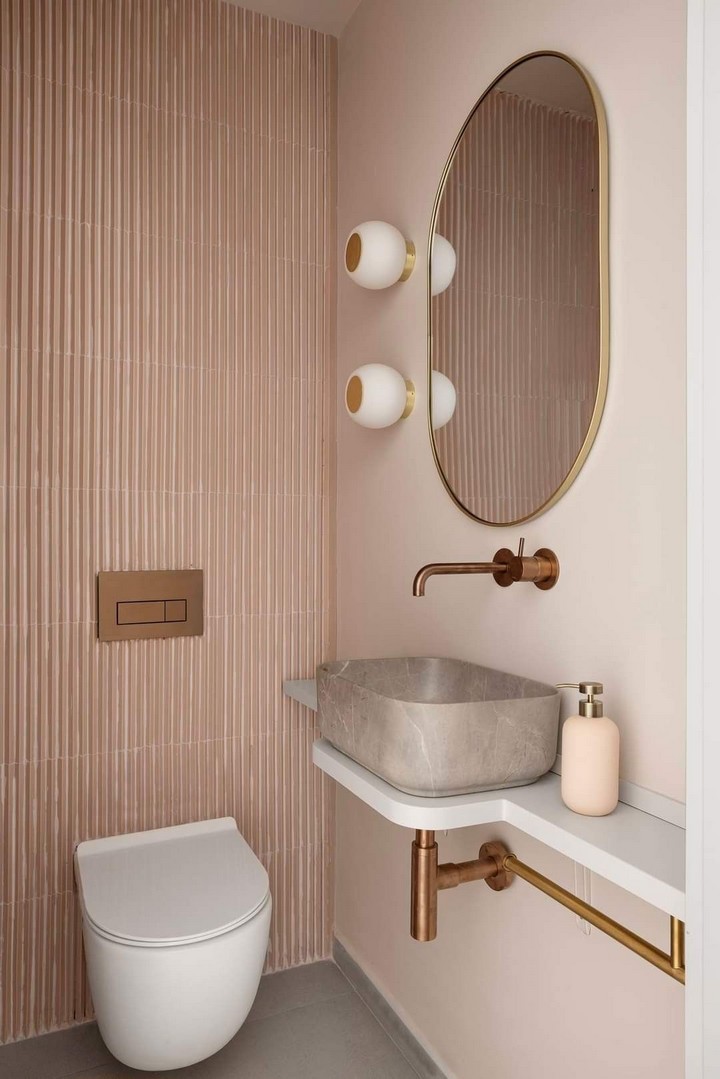 Wall-mounted toilet and sink in powder room