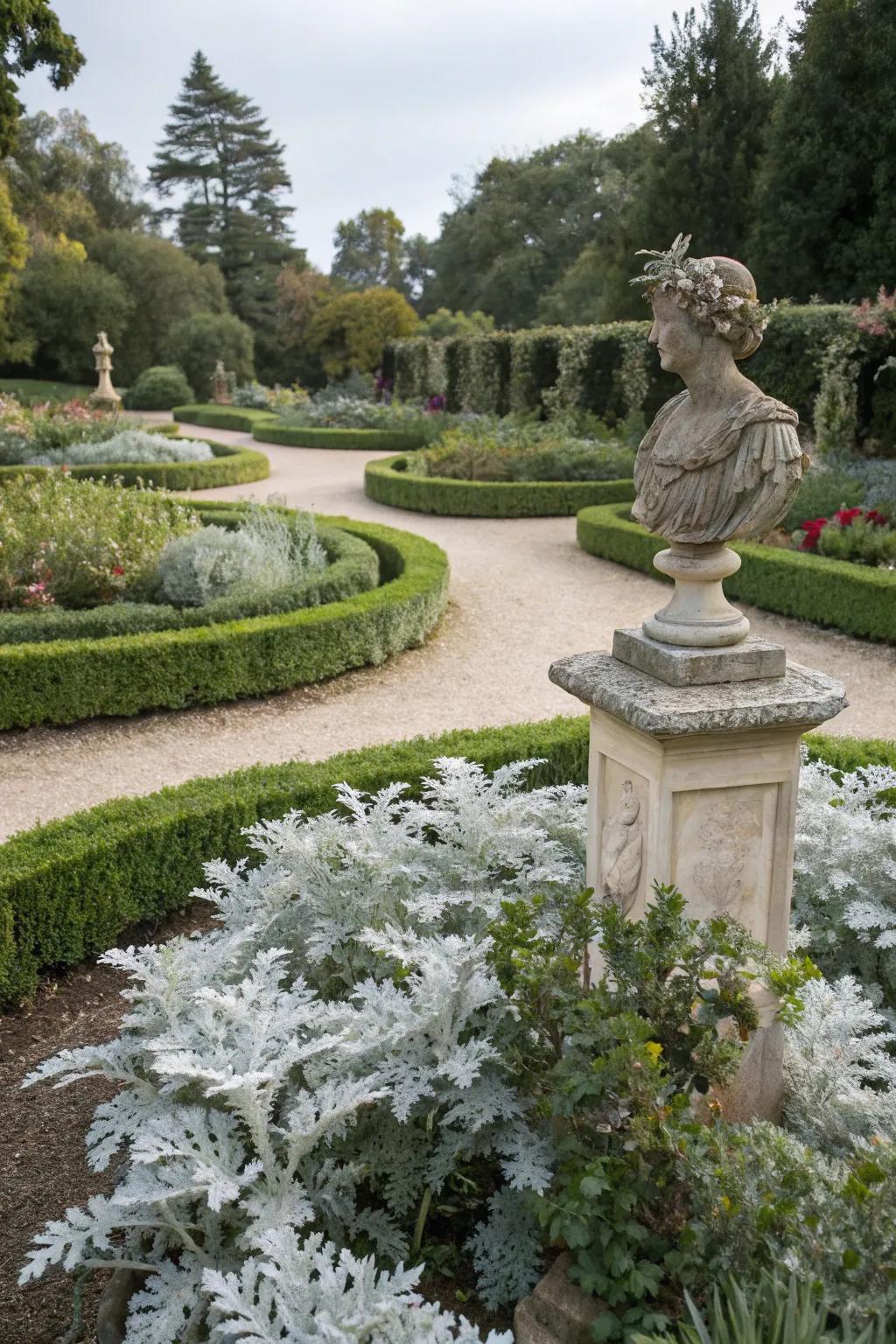 Dusty miller highlights garden sculptures elegantly.
