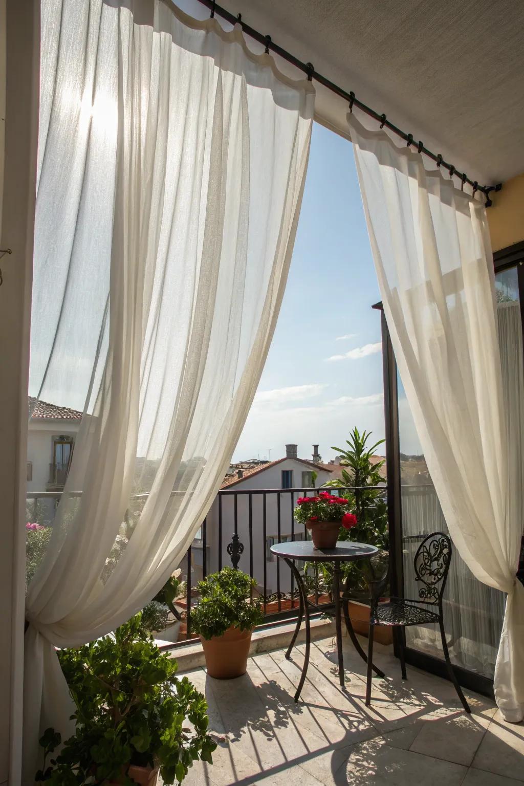 Outdoor curtains gently moving with the breeze on a balcony.