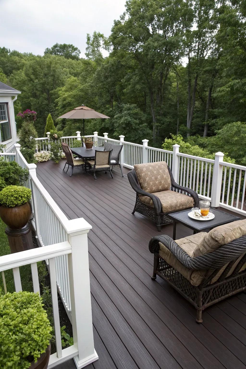 A dark brown deck with elegant white railings and plush seating.