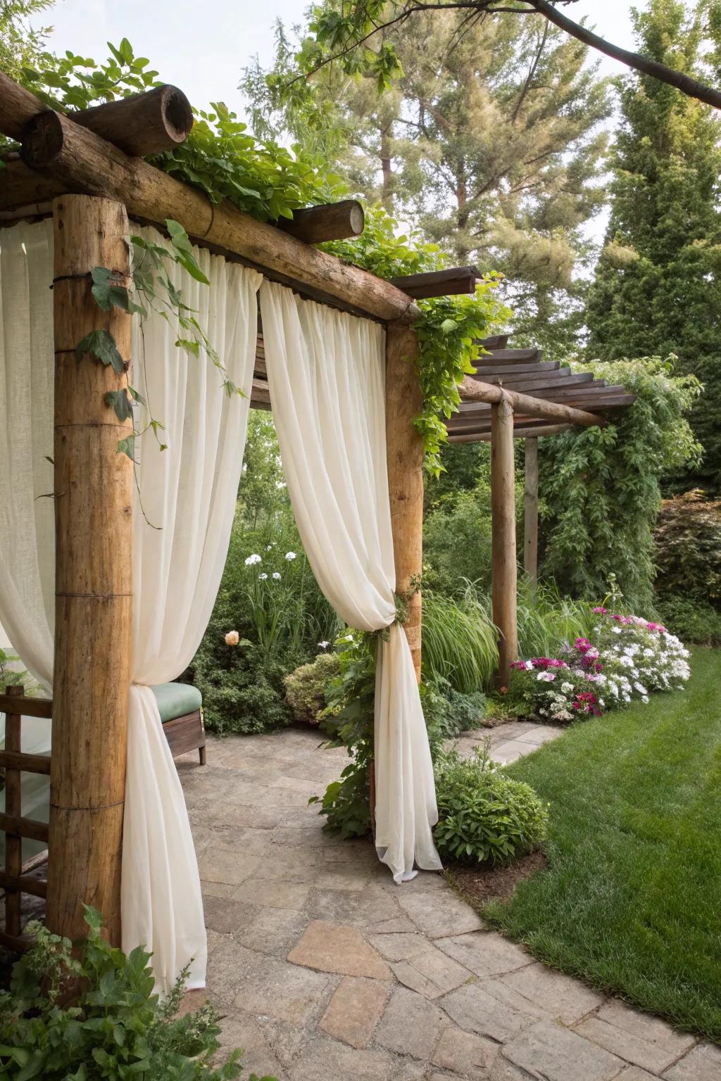 Elegant curtains providing privacy for a log pergola retreat.