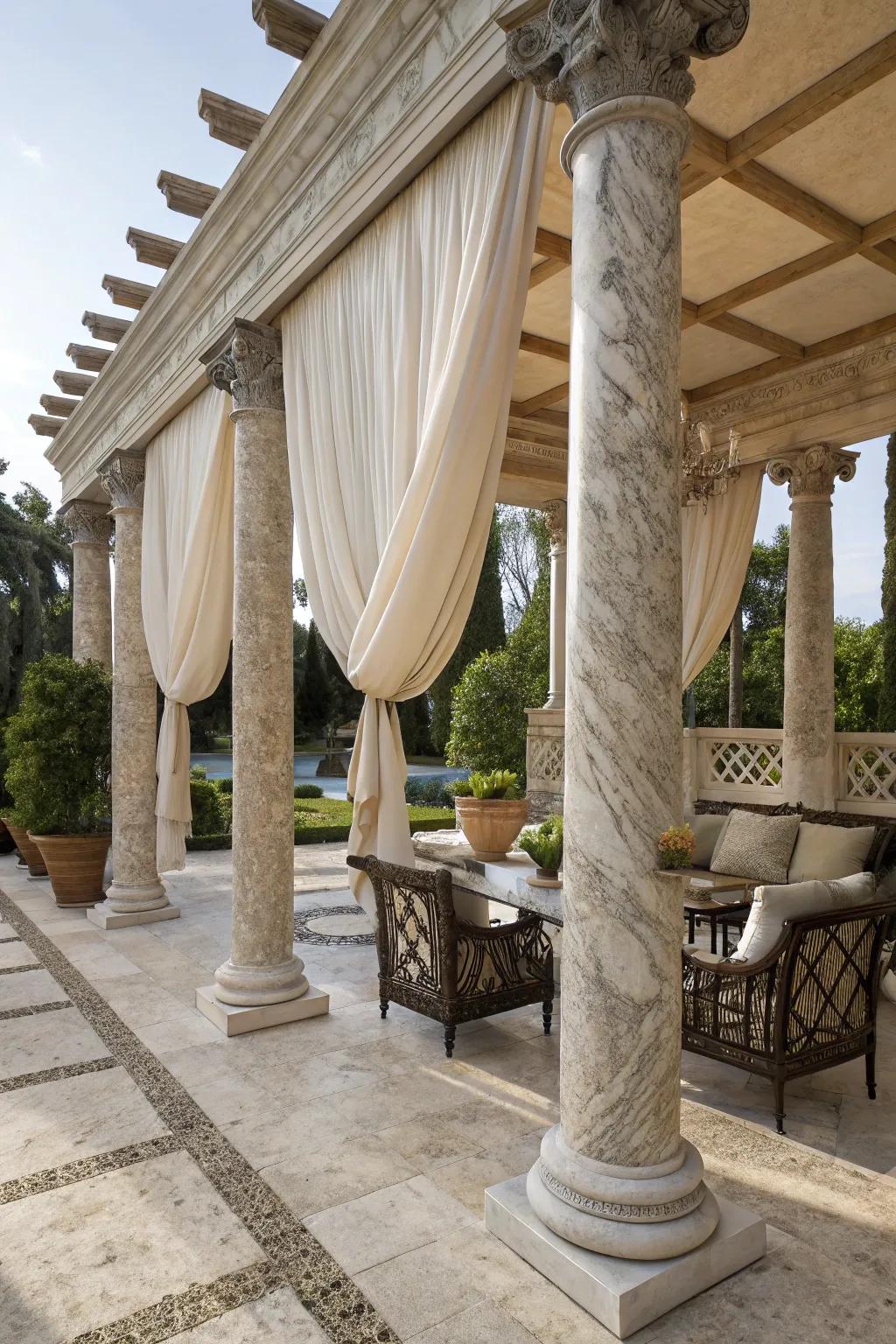 Outdoor canopy featuring marble pillars and flowing fabric.