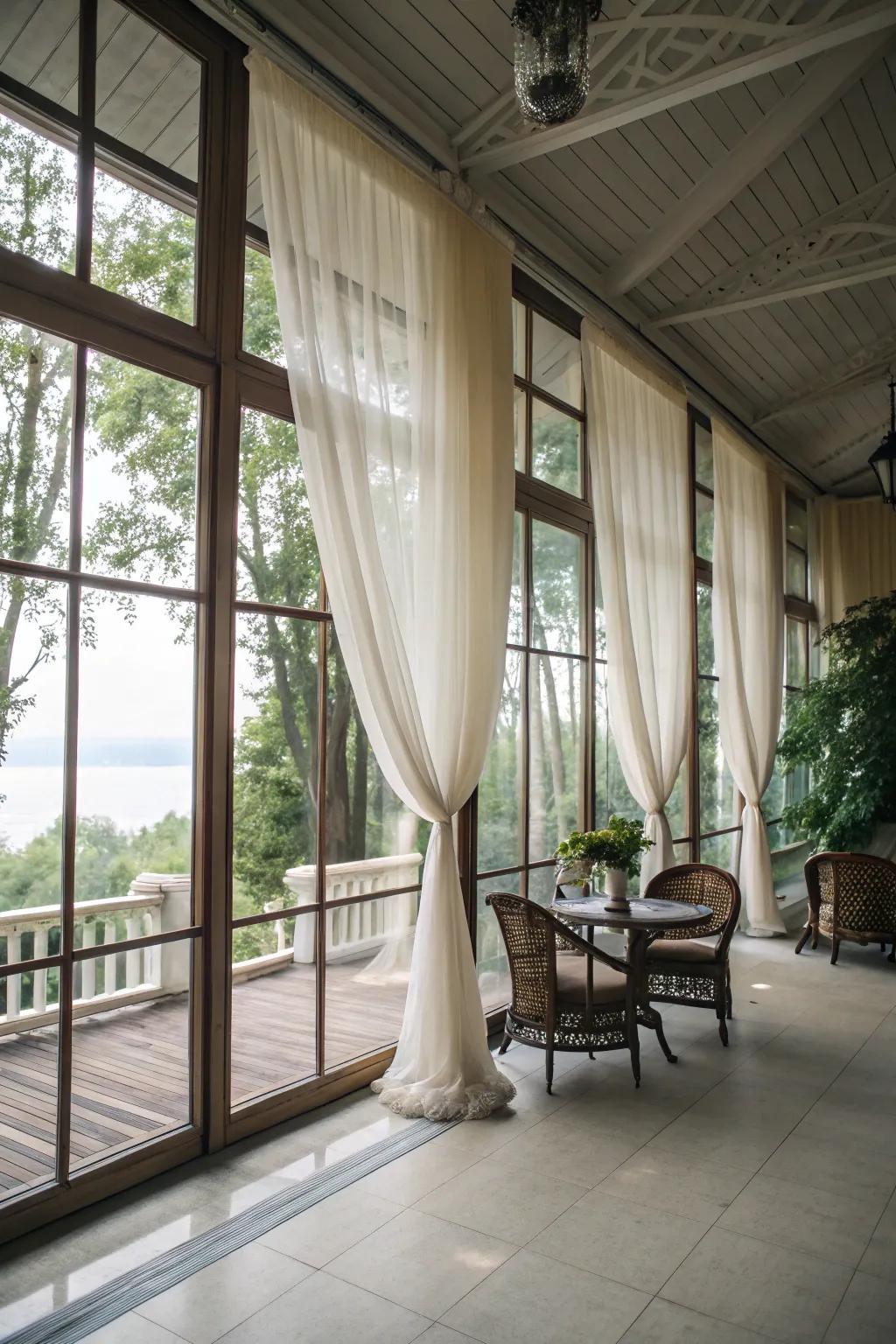 Sheer curtains soften sunlight flooding the porch with radiant warmth.