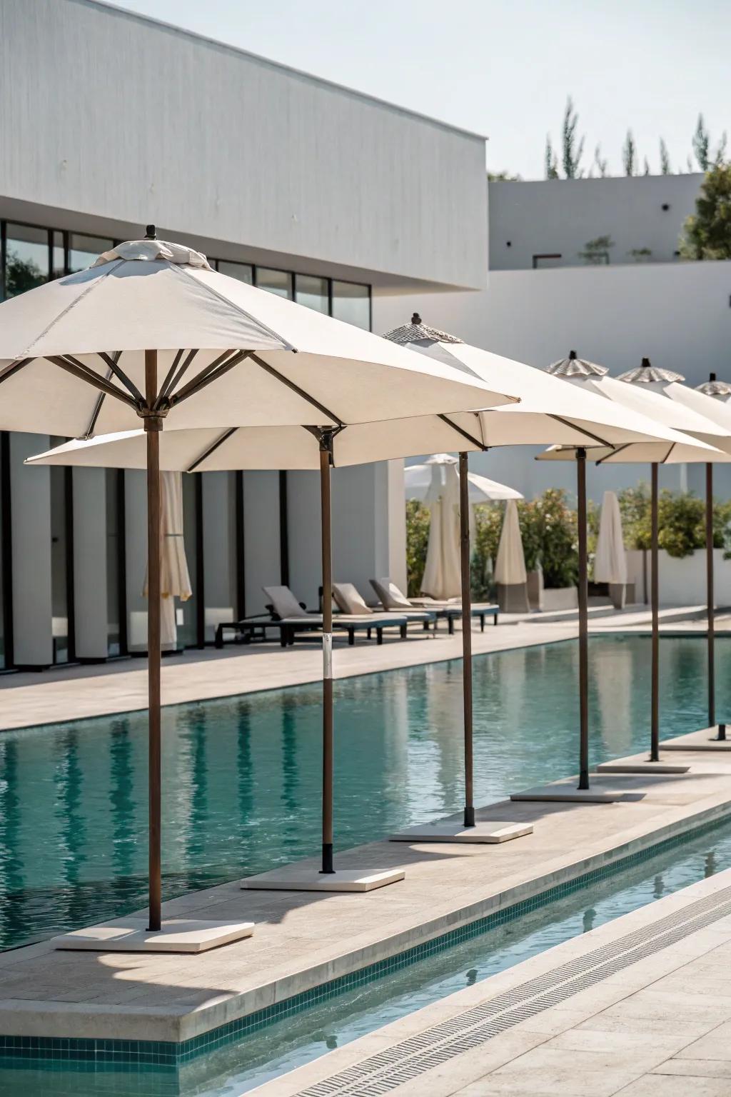 Minimalist umbrellas complementing a sleek and modern poolside area.