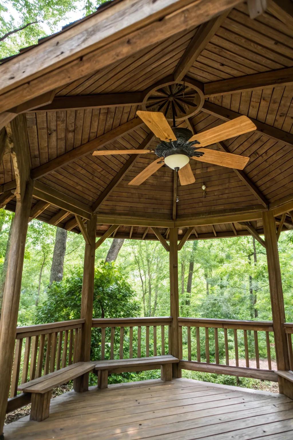 A rustic fan enhances the earthy charm of wooden gazebos.